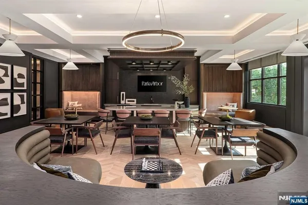 a living room with furniture gym equipment and view of kitchen