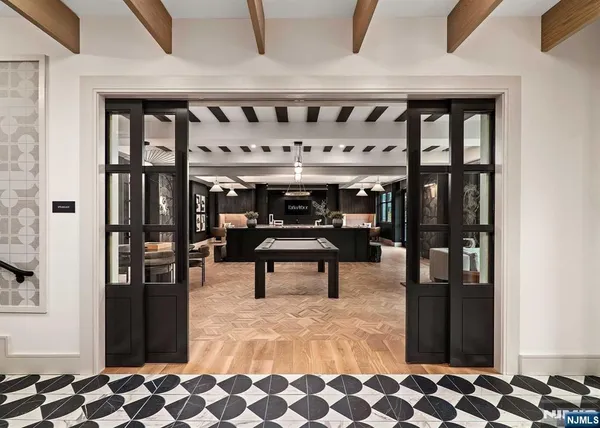 a living room with furniture pool table and a large window