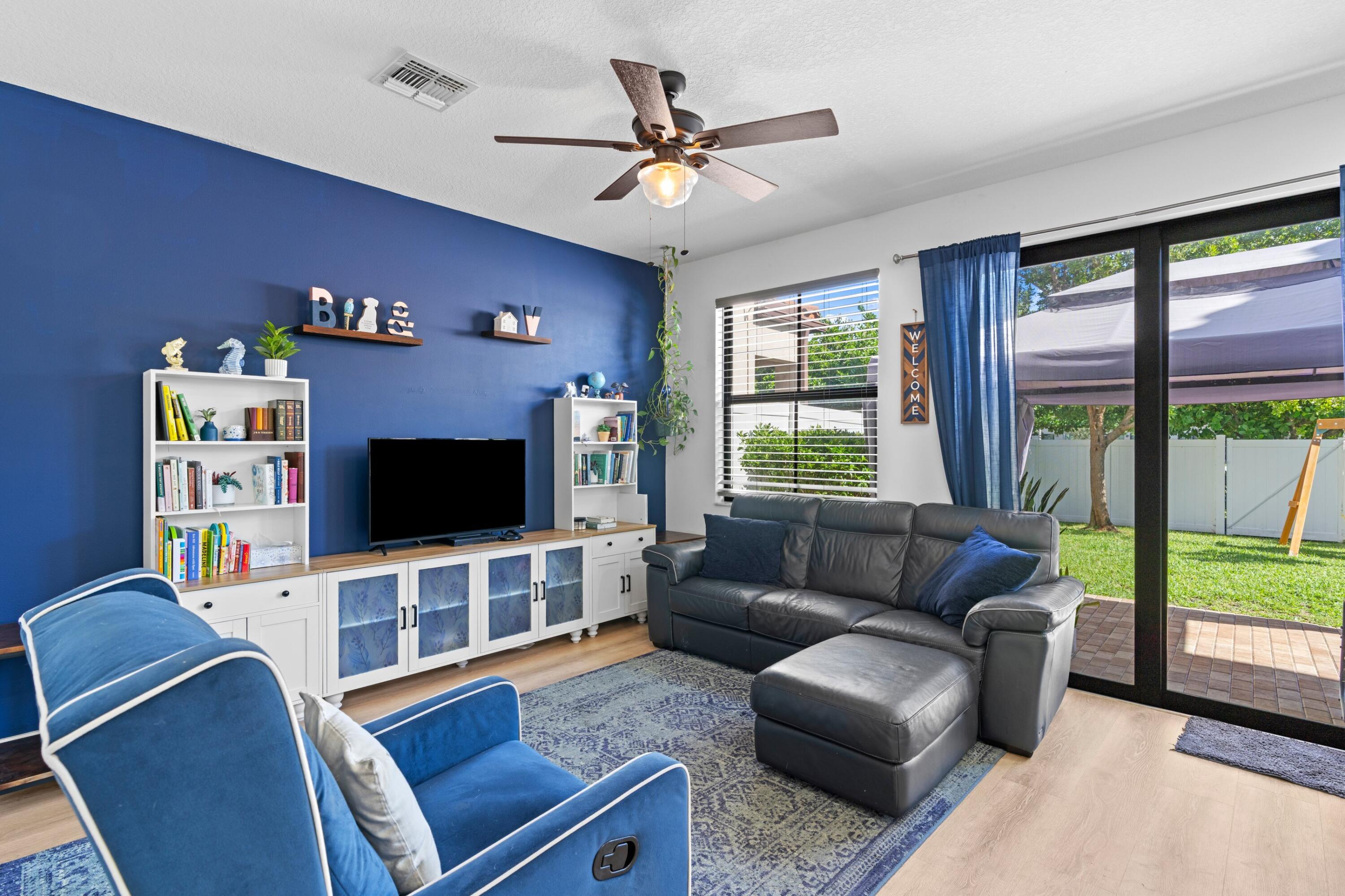 3006 Hoptree Way Riviera Beach, FL 33410 - Photo 11 of 35 a living room with furniture and a flat screen tv