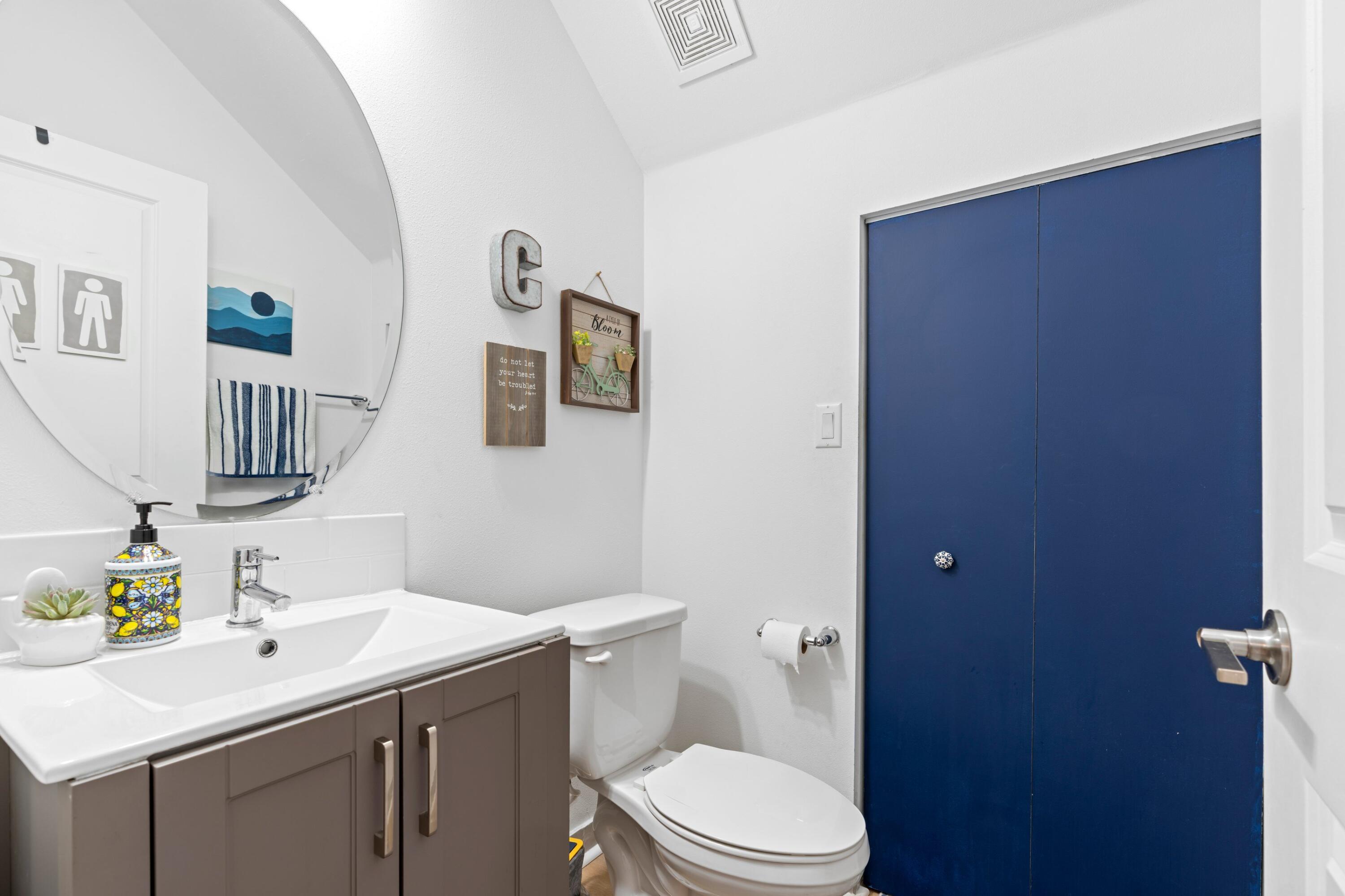 3006 Hoptree Way Riviera Beach, FL 33410 - Photo 12 of 35 a bathroom with a toilet a sink and mirror