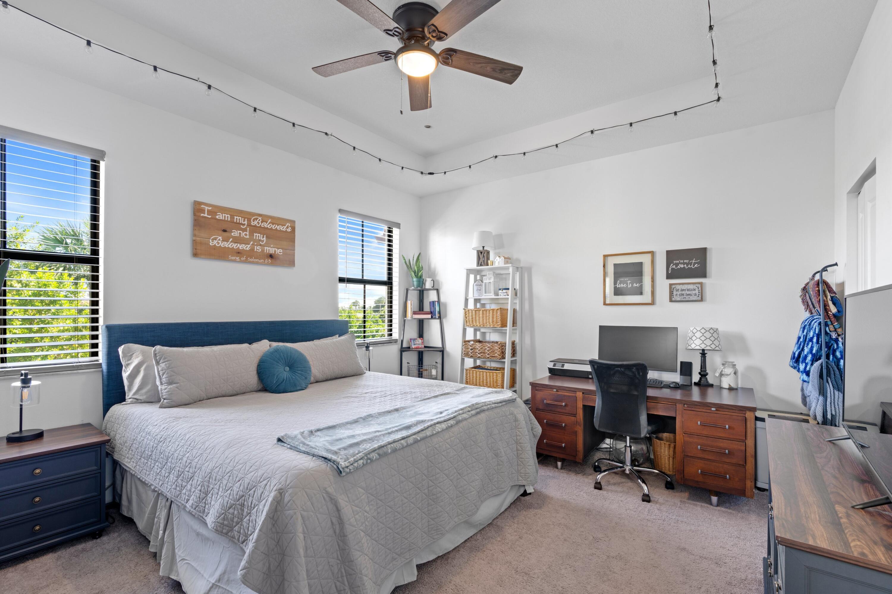 3006 Hoptree Way Riviera Beach, FL 33410 - Photo 13 of 35 a bedroom with a bed and a chandelier