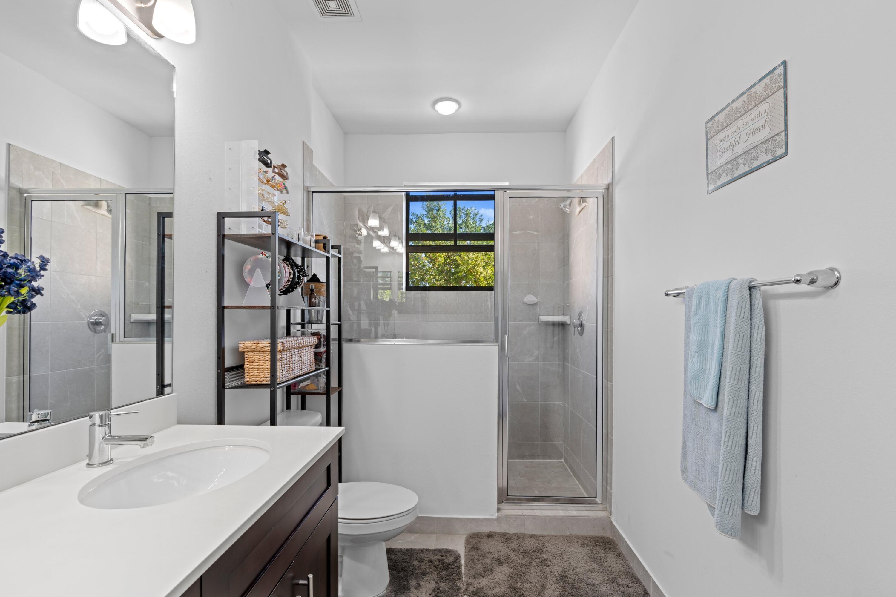 3006 Hoptree Way Riviera Beach, FL 33410 - Photo 16 of 35 a bathroom with a sink toilet and shower