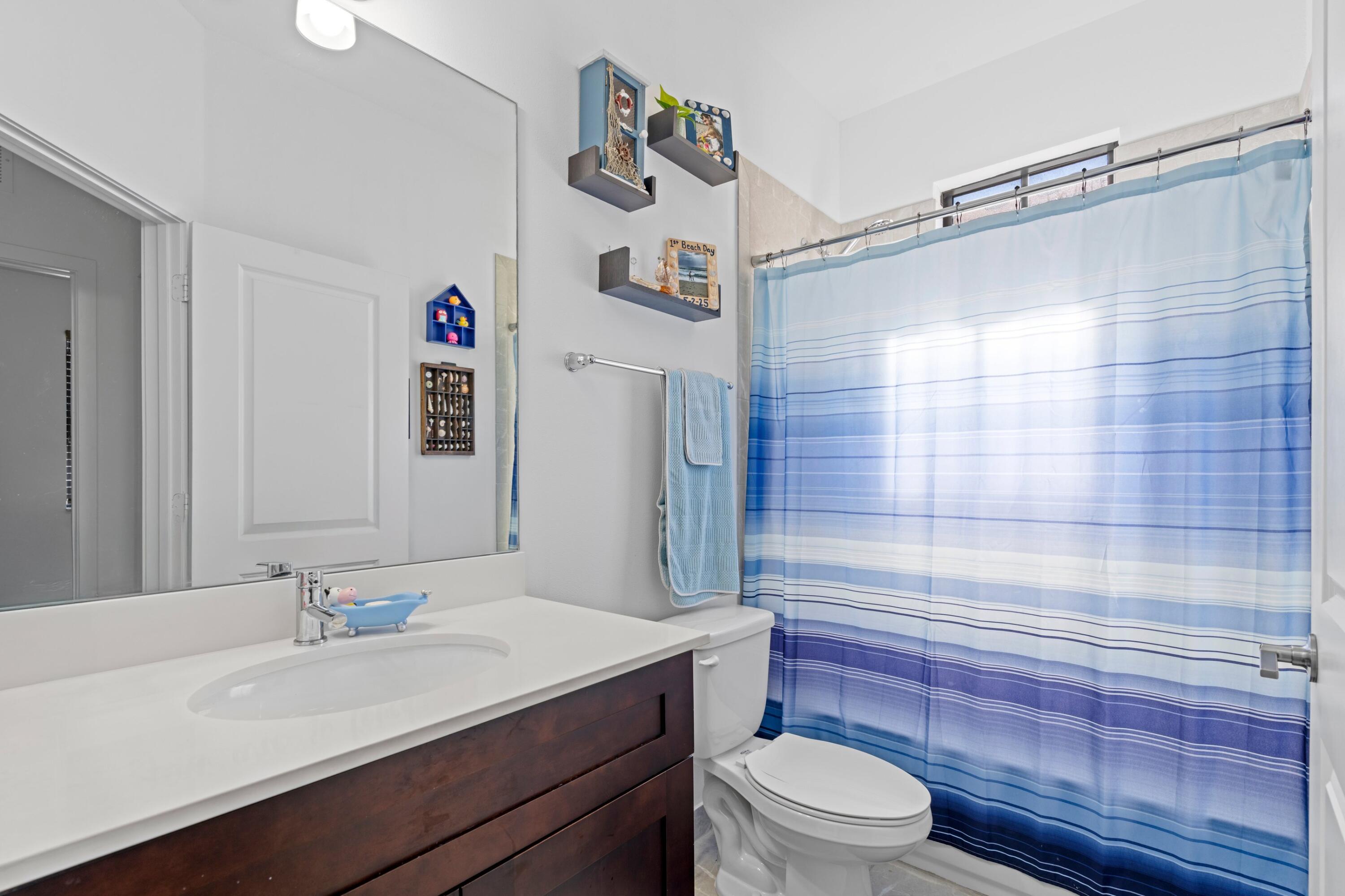 3006 Hoptree Way Riviera Beach, FL 33410 - Photo 19 of 35 a bathroom with a sink a toilet and shower