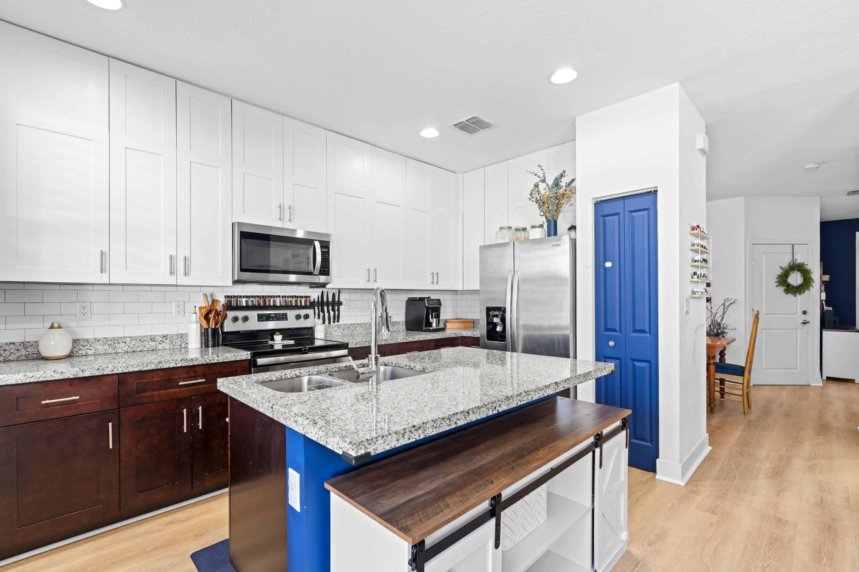 3006 Hoptree Way Riviera Beach, FL 33410 - Photo 7 of 35 a kitchen with stainless steel appliances granite countertop a sink stove and refrigerator