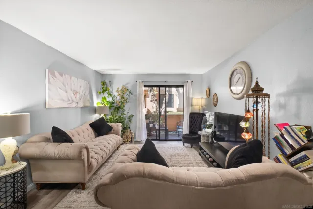 a living room with furniture and a clock