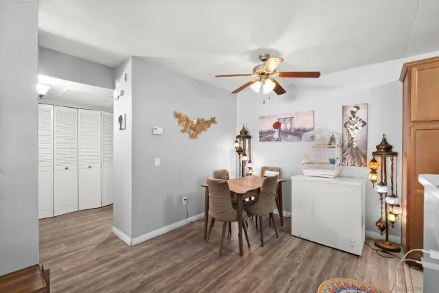 a very nice looking room with kitchen island a wooden floor and a refrigerator