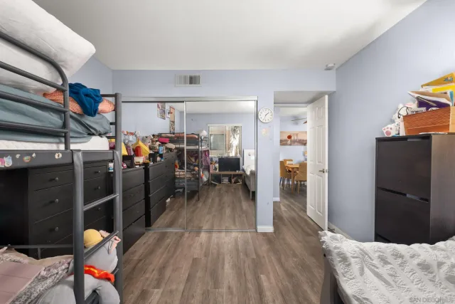a view of a hallway with wooden floor and stairs