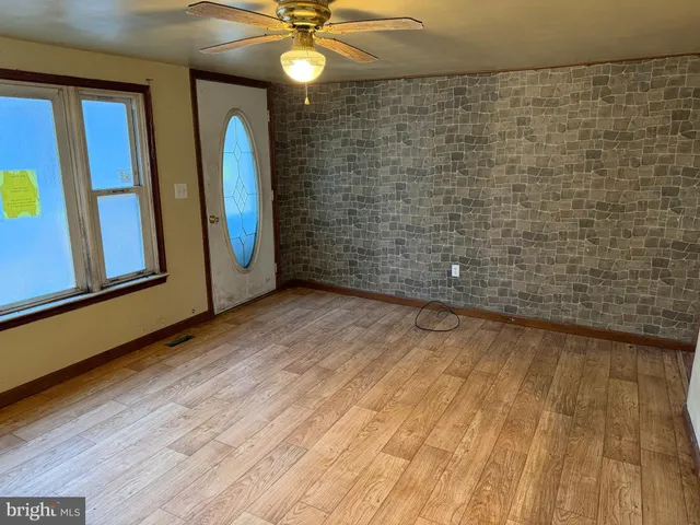 a view of a livingroom with wooden floor and chandelier