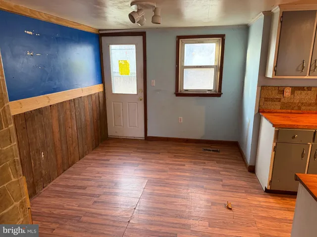 a view of an entryway with wooden floor