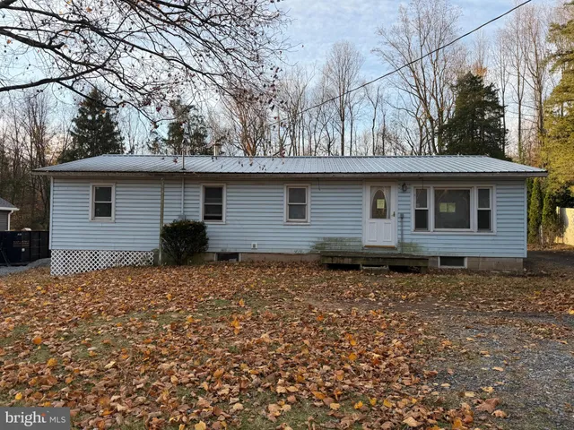 a backyard of a house with large trees