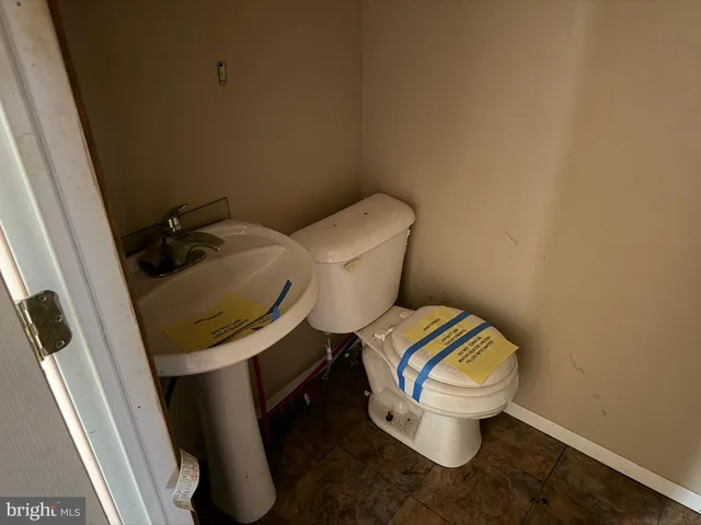 a white toilet sitting next to a small sink