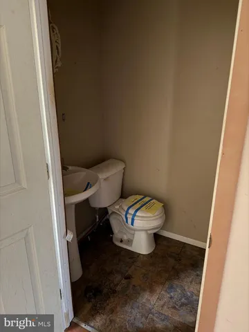 a white toilet sitting next to a small sink