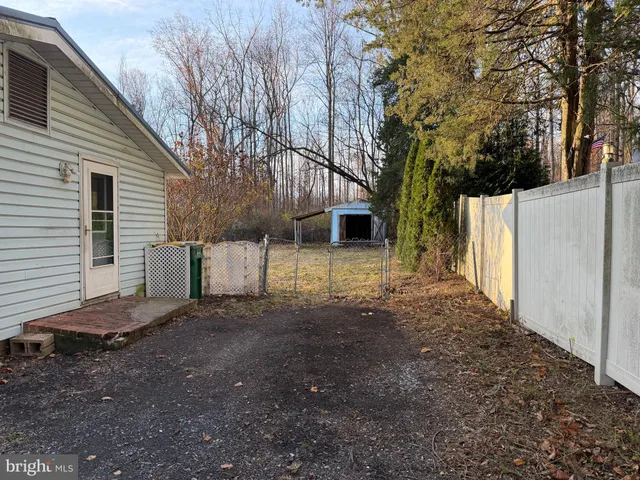 a view of a house with a yard and tree s