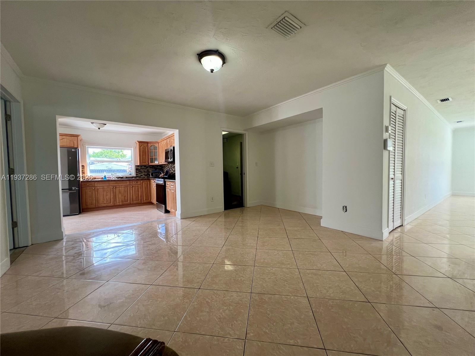 11950 Southwest 199th Street, Unit 1 Miami, FL 33177 - Photo 12 of 30 a view of a livingroom with kitchen and view of living room