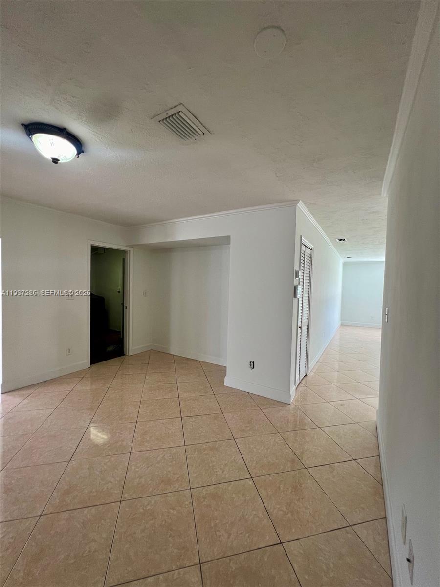 11950 Southwest 199th Street, Unit 1 Miami, FL 33177 - Photo 13 of 30 a view of an empty room with a window