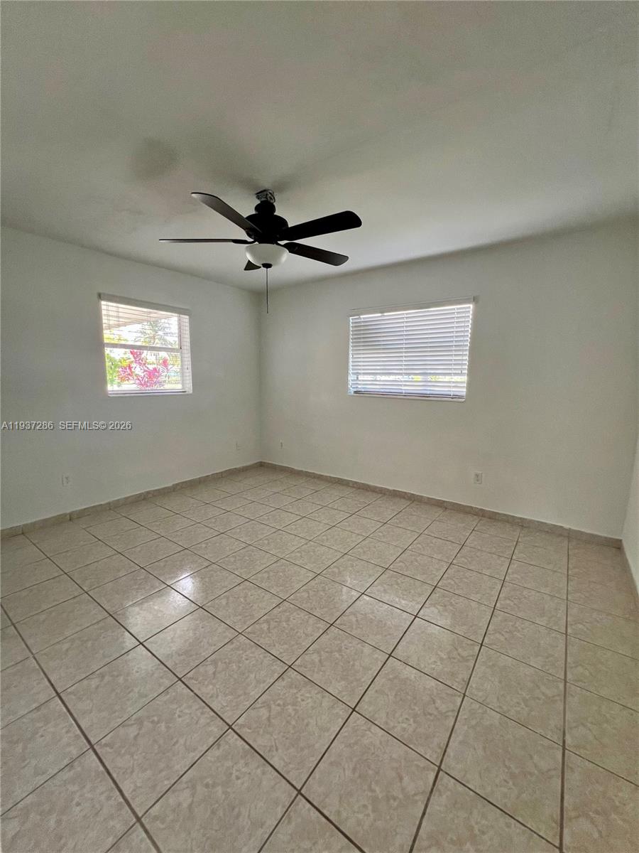 11950 Southwest 199th Street, Unit 1 Miami, FL 33177 - Photo 16 of 30 a view of an empty room with a window