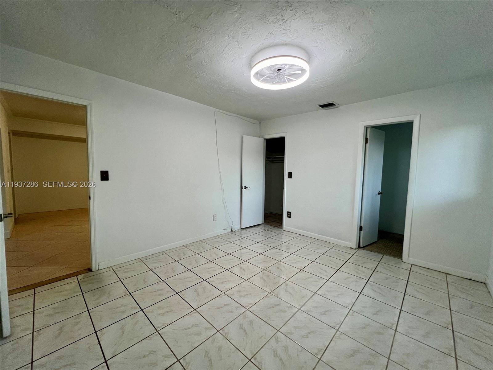 11950 Southwest 199th Street, Unit 1 Miami, FL 33177 - Photo 19 of 30 an empty room with windows