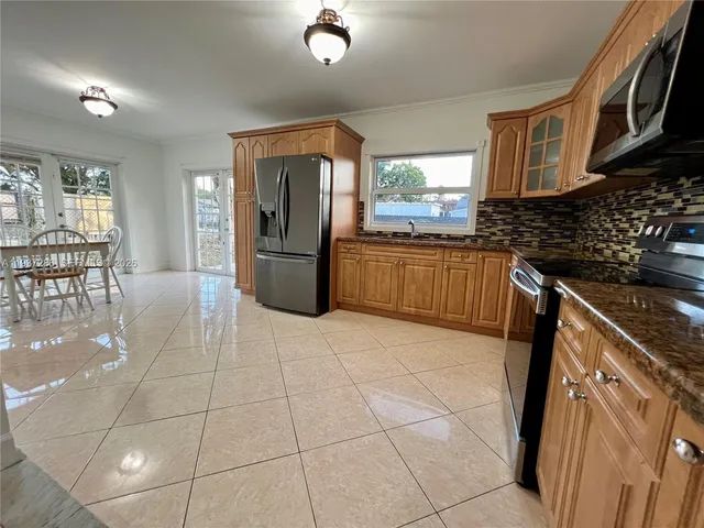 a view of storage and utility room with wooden floor