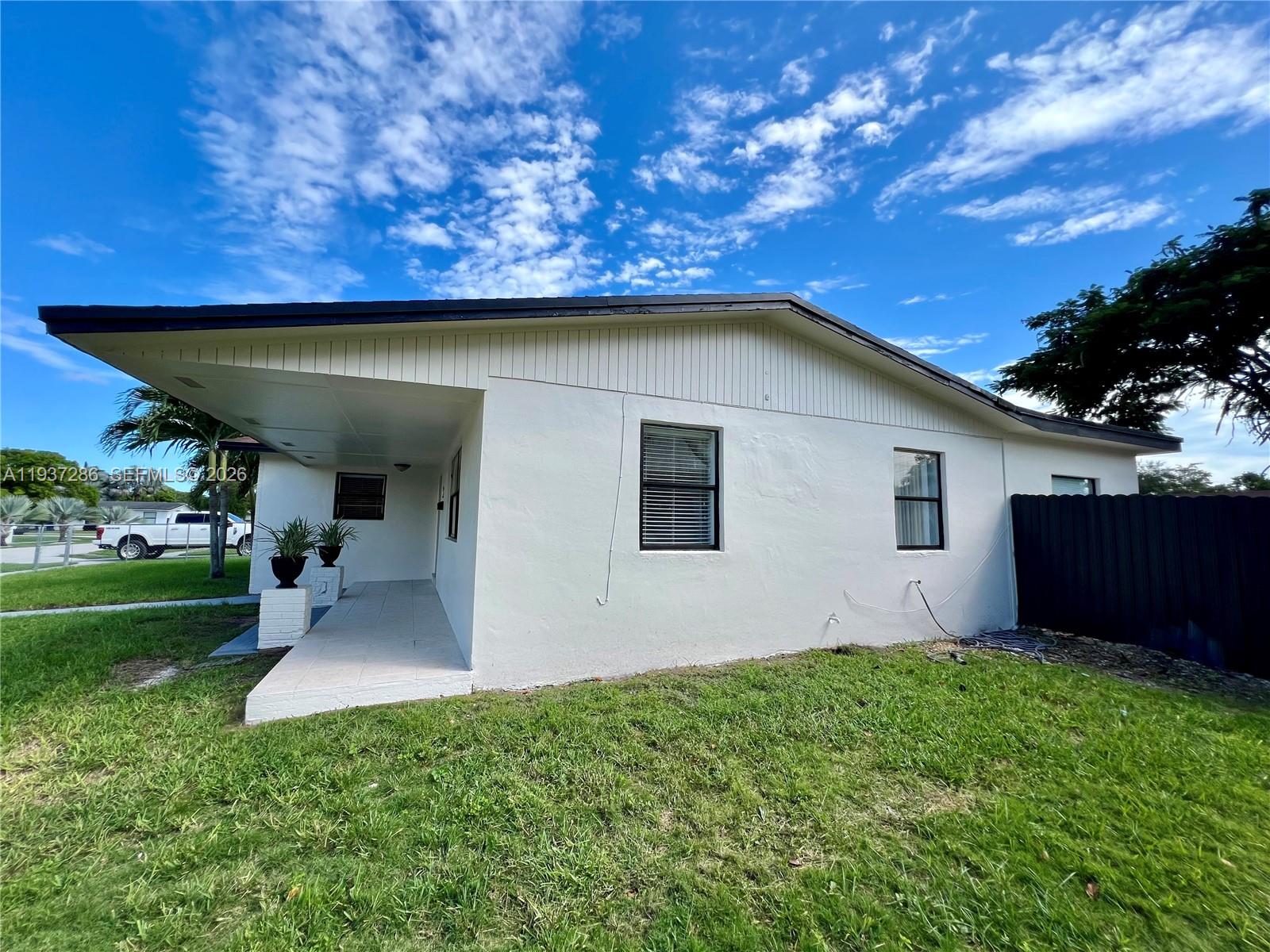 11950 Southwest 199th Street, Unit 1 Miami, FL 33177 - Photo 5 of 30 a house view with a backyard space