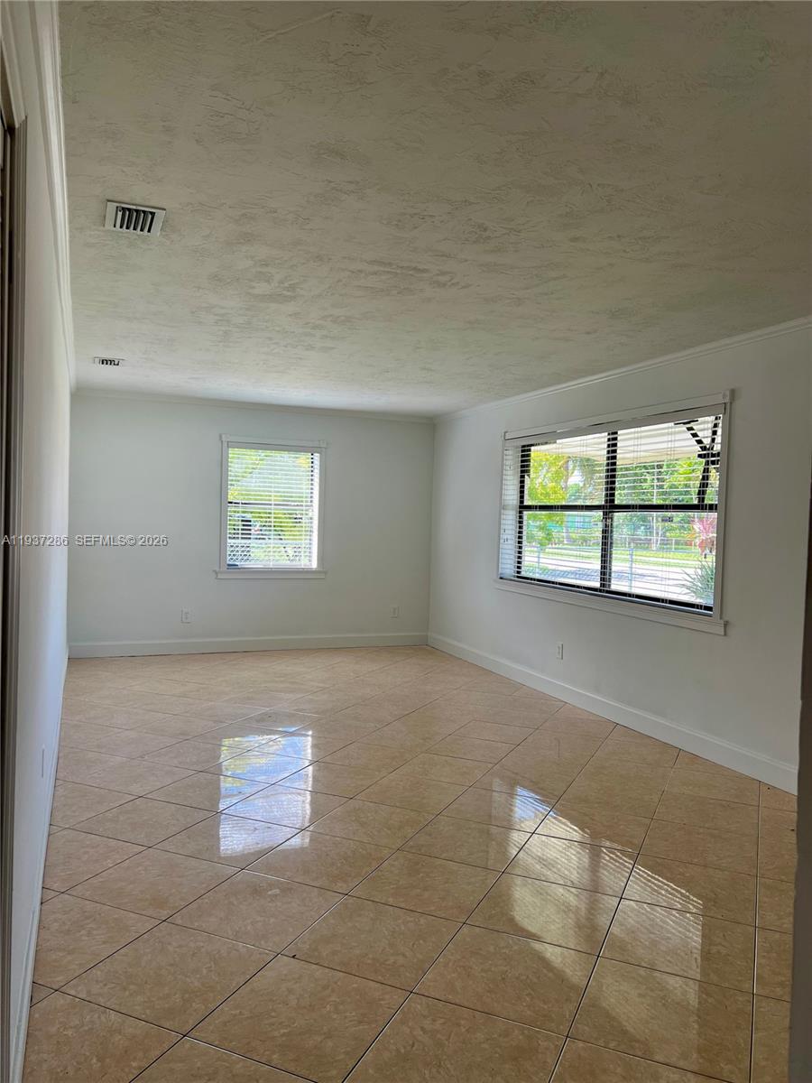 11950 Southwest 199th Street, Unit 1 Miami, FL 33177 - Photo 6 of 30 a view of an empty room with a window