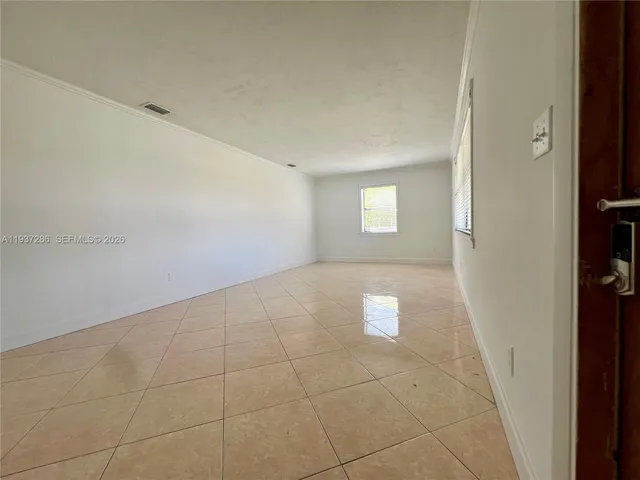 a view of an empty room with a window