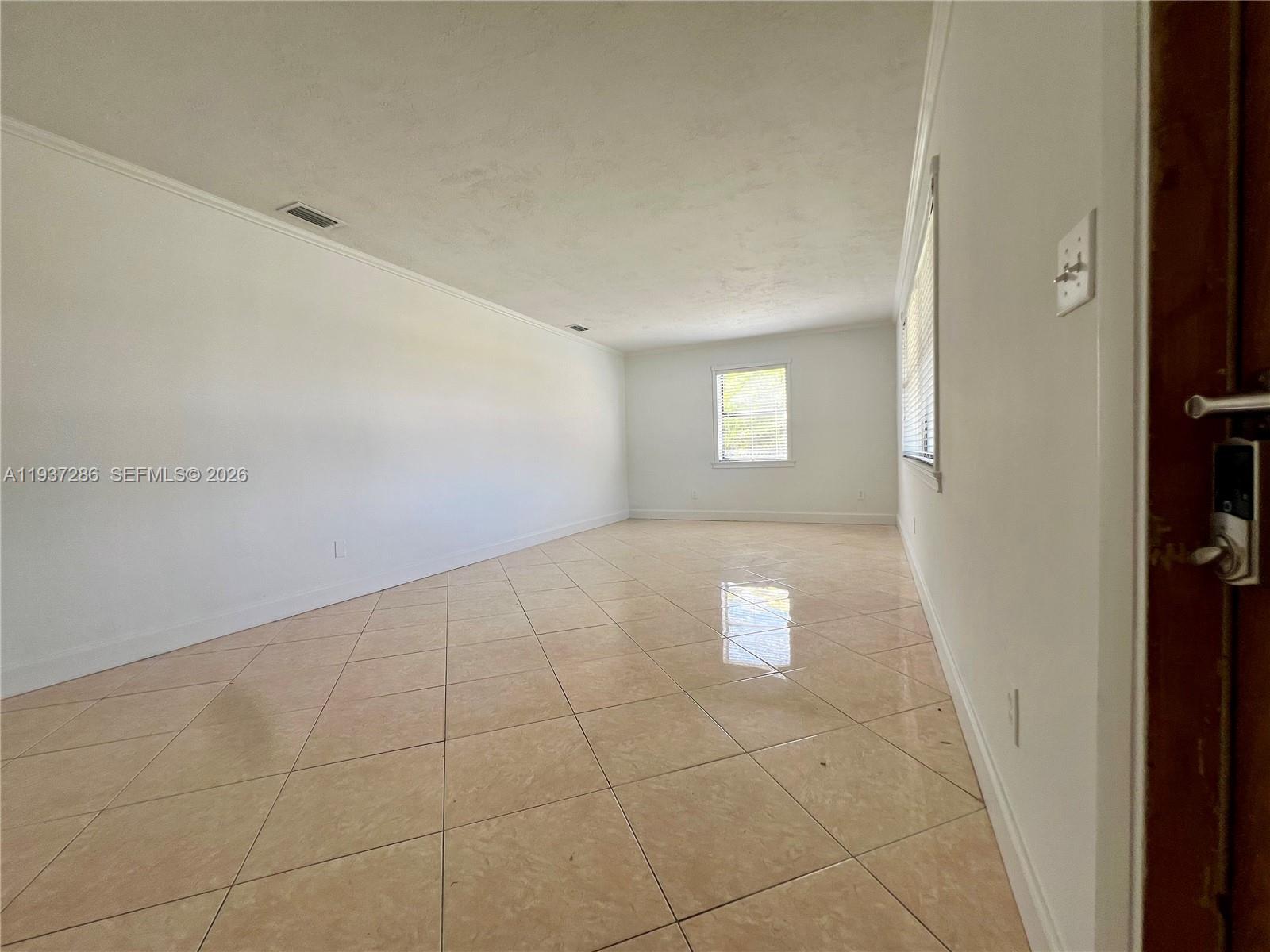 11950 Southwest 199th Street, Unit 1 Miami, FL 33177 - Photo 9 of 30 a view of an empty room with a window