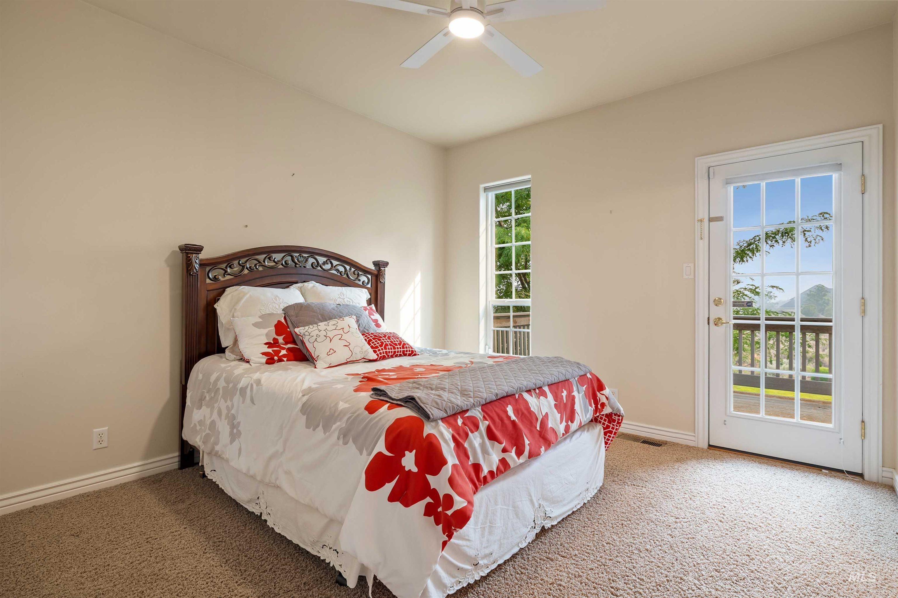 3404 Ridge Line Drive Kimberly, ID 83341 - Photo 29 of 50 Carpeted room featuring a ceiling fan, a tall vertical window, and a full-light glass panel door leading to an outdoor deck