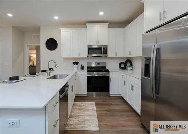 a kitchen with cabinets and stainless steel appliances