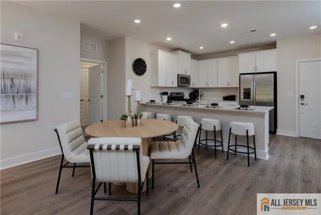 a kitchen with a table and chairs in it