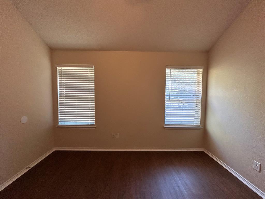 7917 Rattlers Court Arlington, TX 76002 - Photo 14 of 21 an empty room with wooden floor and windows