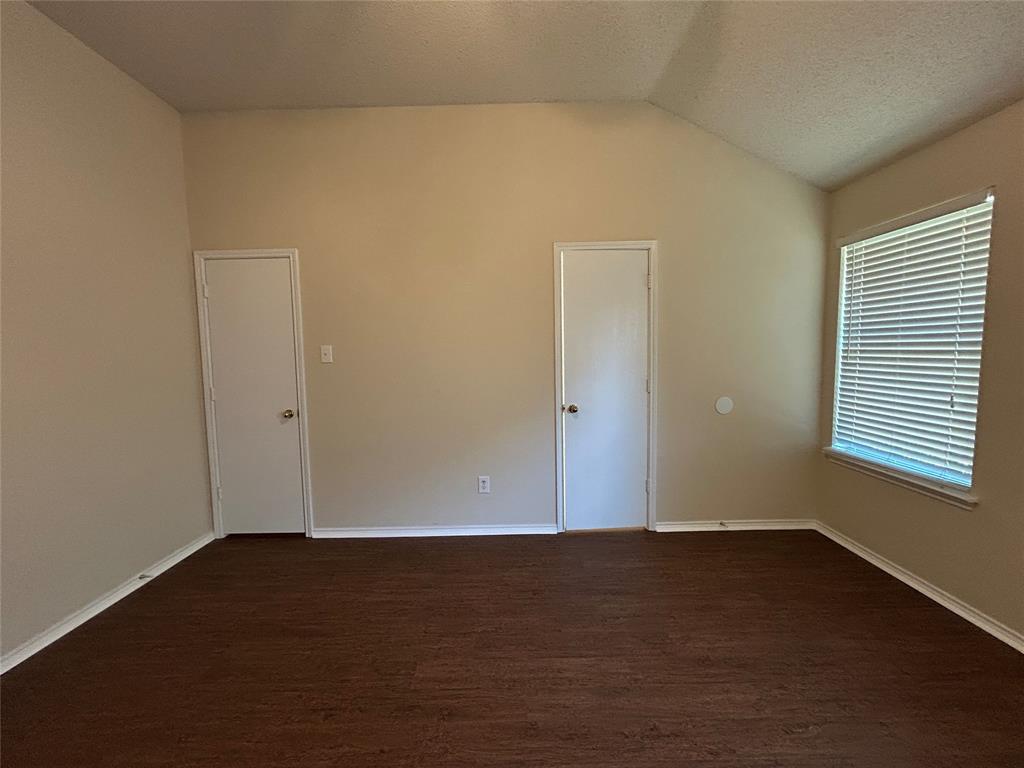 7917 Rattlers Court Arlington, TX 76002 - Photo 16 of 21 an empty room with wooden floor and windows
