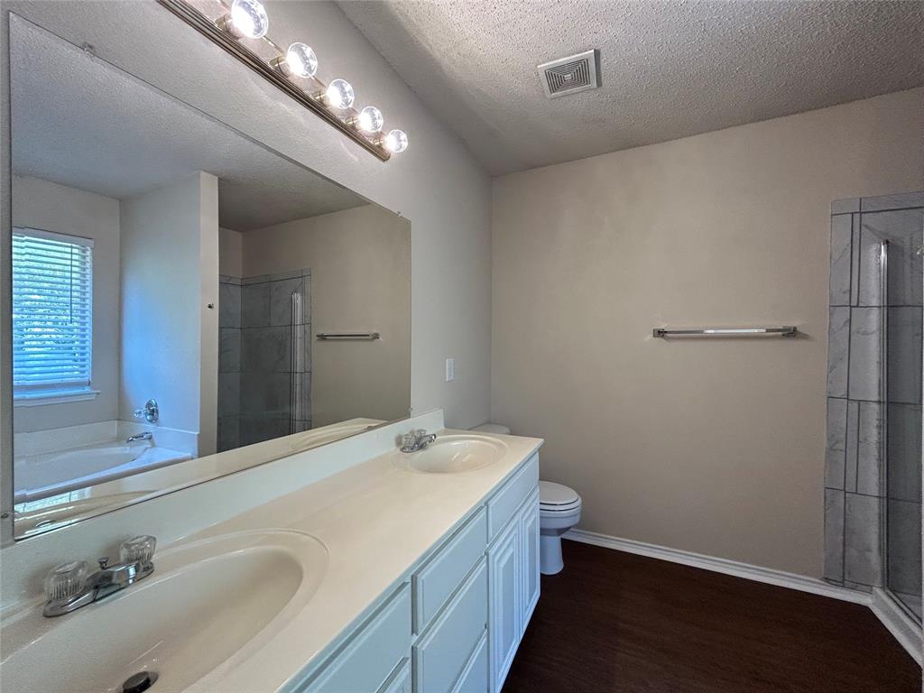 7917 Rattlers Court Arlington, TX 76002 - Photo 17 of 21 a bathroom with a sink and a toilet