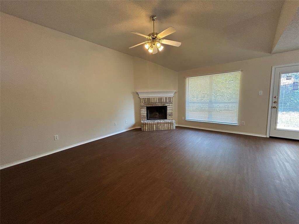 7917 Rattlers Court Arlington, TX 76002 - Photo 2 of 21 an empty room with windows and fireplace