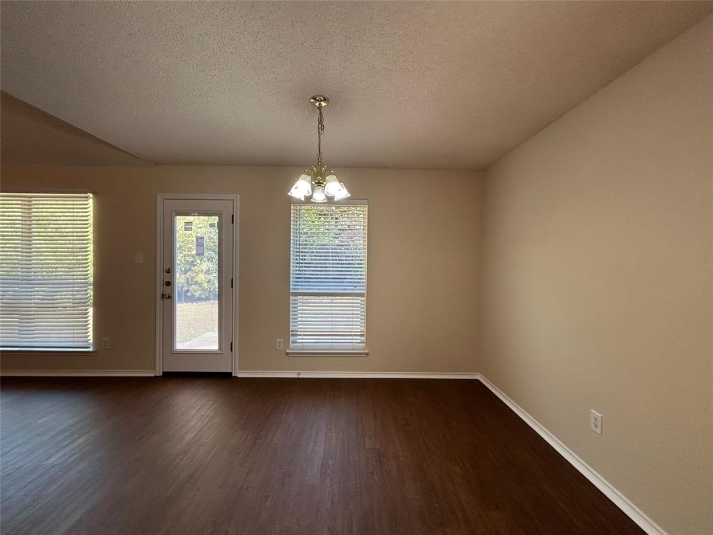 7917 Rattlers Court Arlington, TX 76002 - Photo 3 of 21 an empty room with wooden floor and windows