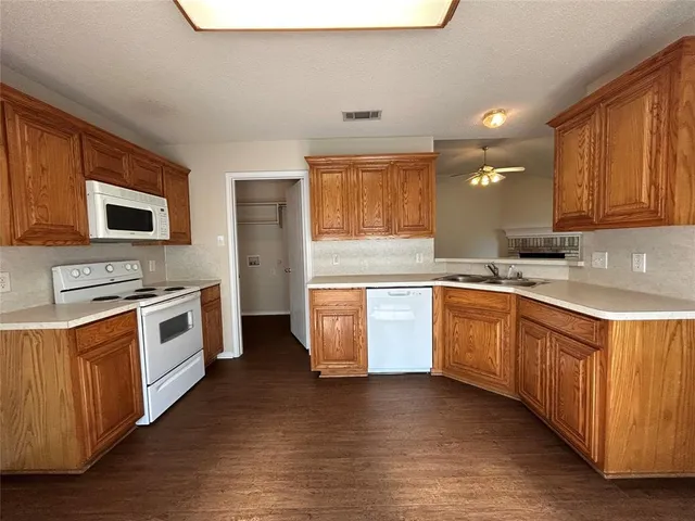 a kitchen with a stove top oven sink and cabinets