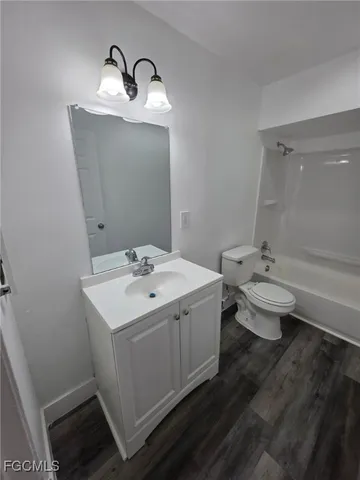 a bathroom with a sink toilet and a mirror