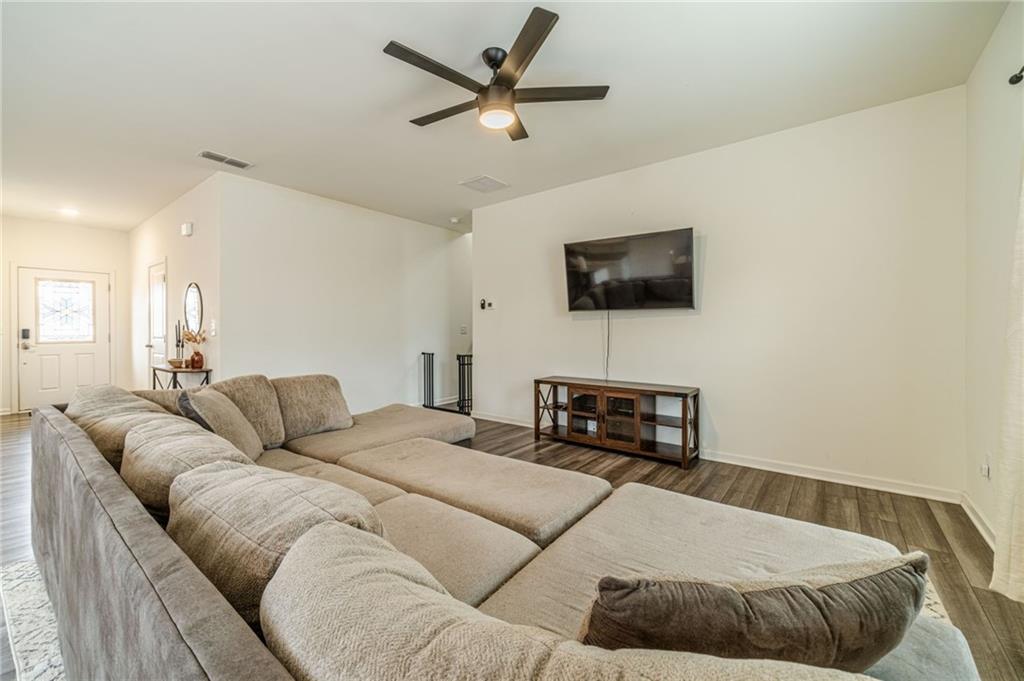 222 Knightsbridge Lane Winder, GA 30680 - Photo 12 of 39 a bedroom with a bed a flat screen tv and a couch