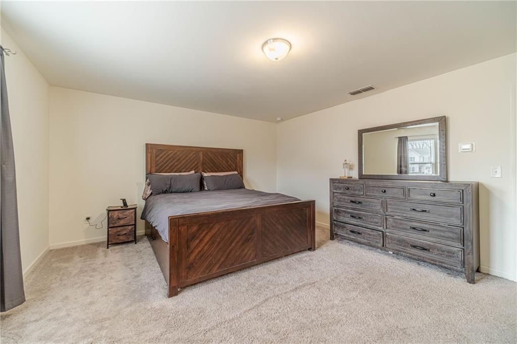 222 Knightsbridge Lane Winder, GA 30680 - Photo 19 of 39 a bedroom with a bed and a dresser