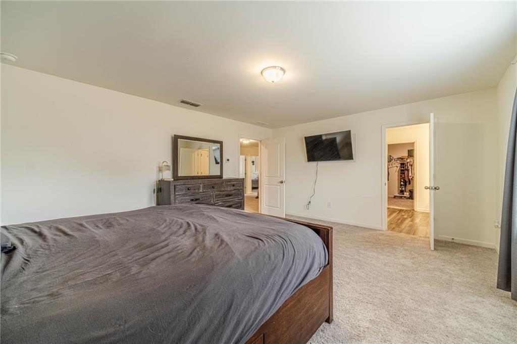 222 Knightsbridge Lane Winder, GA 30680 - Photo 20 of 39 a spacious bedroom with a bed and a flat screen tv
