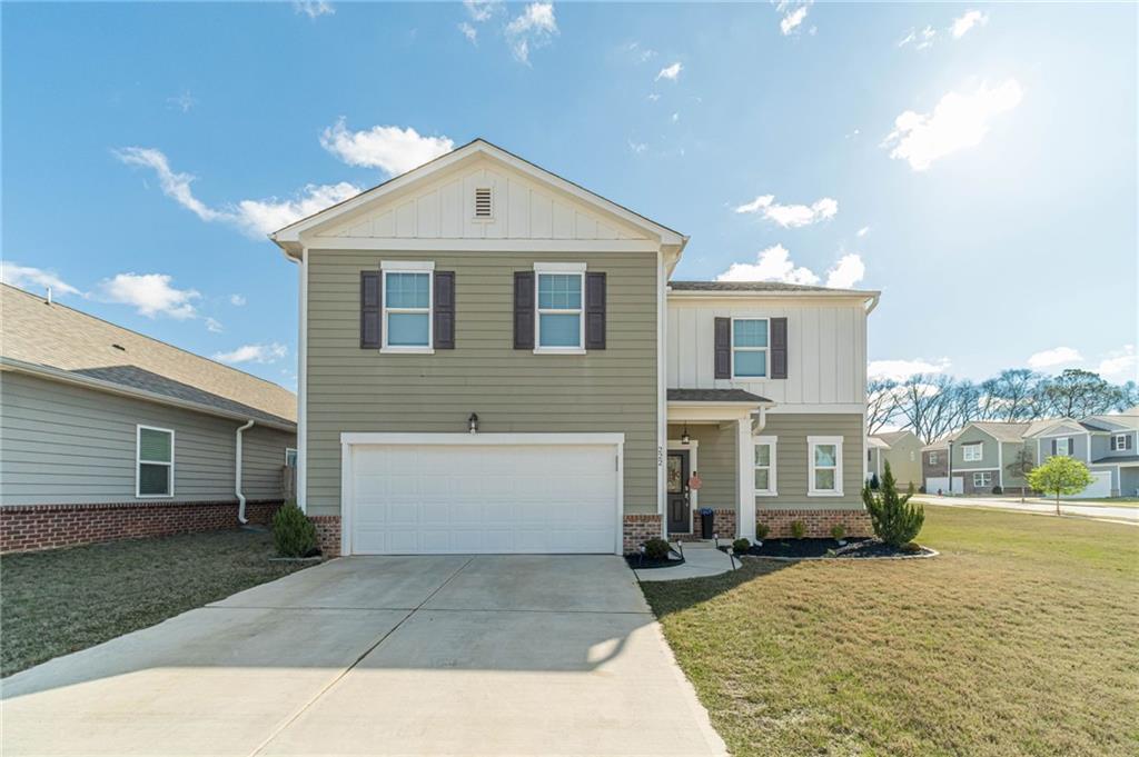 222 Knightsbridge Lane Winder, GA 30680 - Photo 2 of 39 a front view of a house with a yard and garage