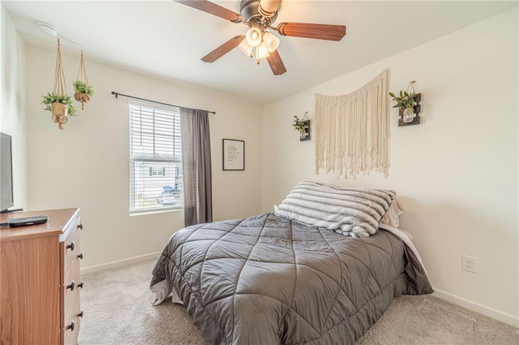 222 Knightsbridge Lane Winder, GA 30680 - Photo 29 of 39 a bedroom with a bed and a chandelier