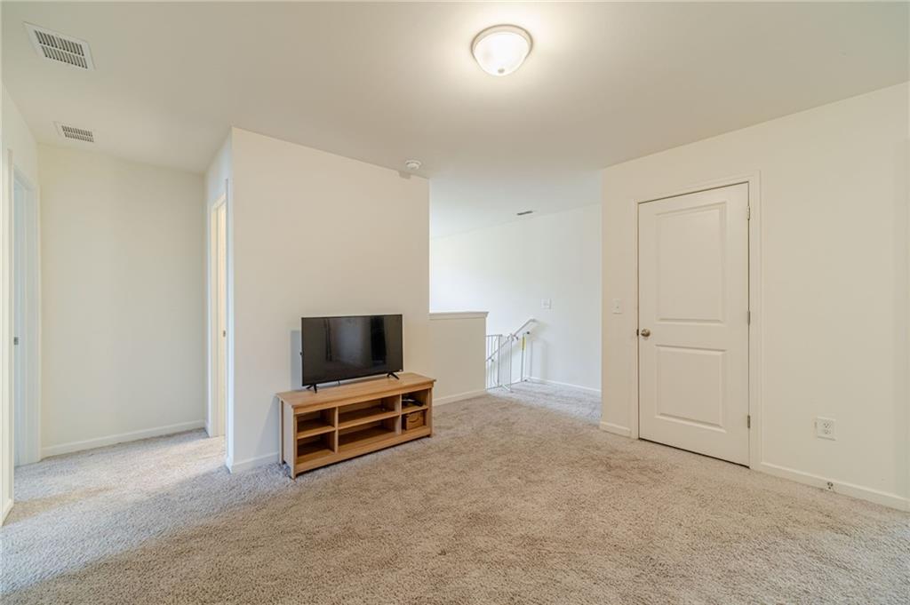 222 Knightsbridge Lane Winder, GA 30680 - Photo 30 of 39 a living room with a flat screen tv and refrigerator