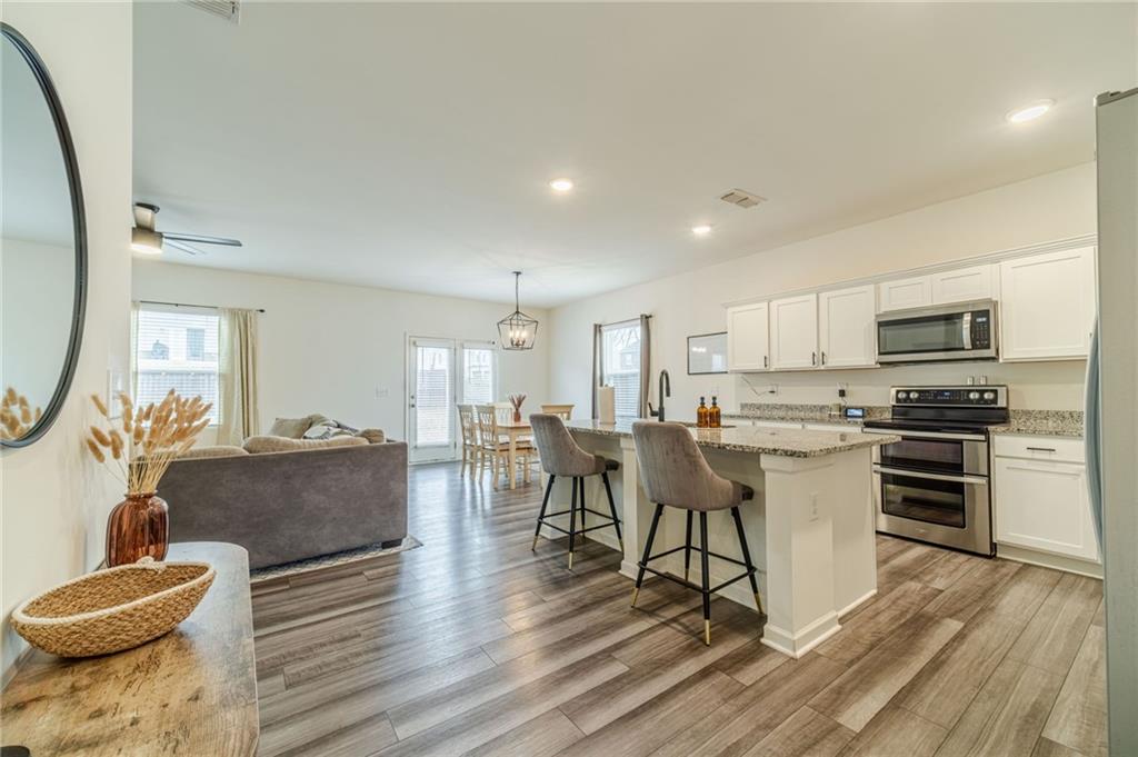 222 Knightsbridge Lane Winder, GA 30680 - Photo 5 of 39 a living room with stainless steel appliances furniture and a kitchen view