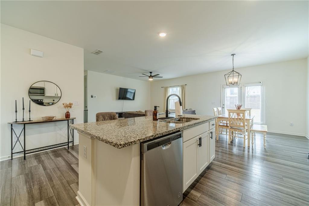 222 Knightsbridge Lane Winder, GA 30680 - Photo 7 of 39 a kitchen with a sink chairs and wooden floor