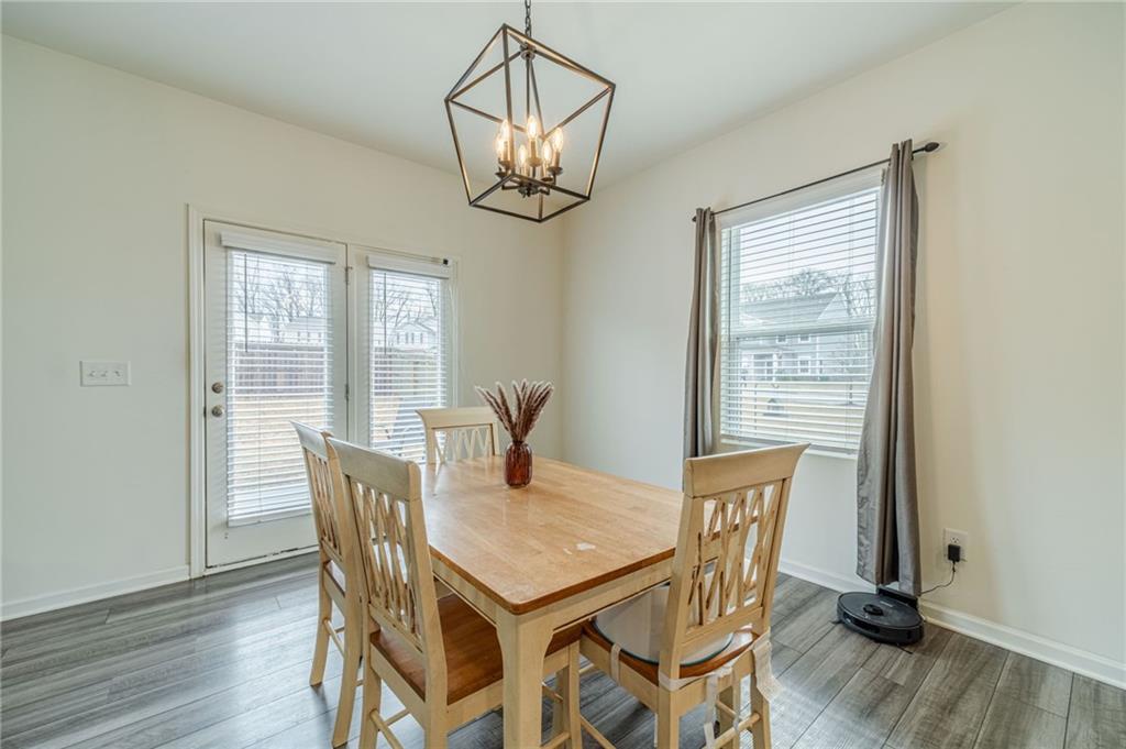 222 Knightsbridge Lane Winder, GA 30680 - Photo 10 of 39 a view of a dining room with furniture a chandelier and wooden floor