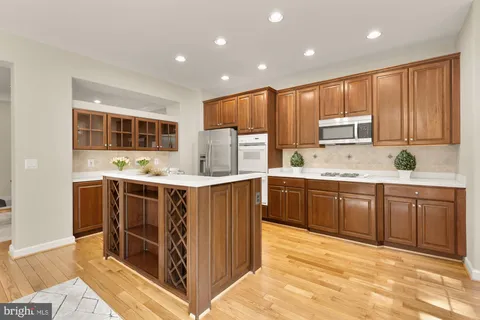 a kitchen with stainless steel appliances granite countertop a refrigerator sink and cabinets