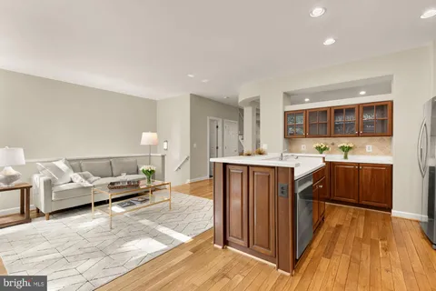 a kitchen with stainless steel appliances a sink stove and cabinets