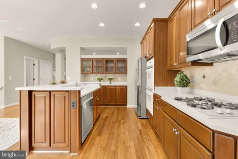 a kitchen with stainless steel appliances granite countertop a sink and a stove