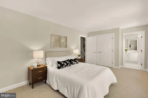 a spacious bedroom with a bed and a couch