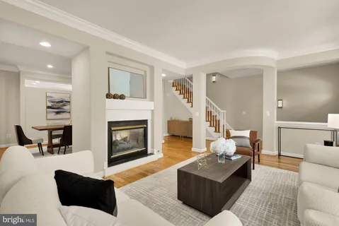 a living room with a fireplace and a rug